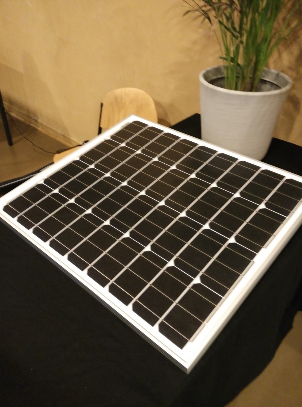Close-up of a monocrystalline solar panel showing its uniform all-black, rounded-corner cells