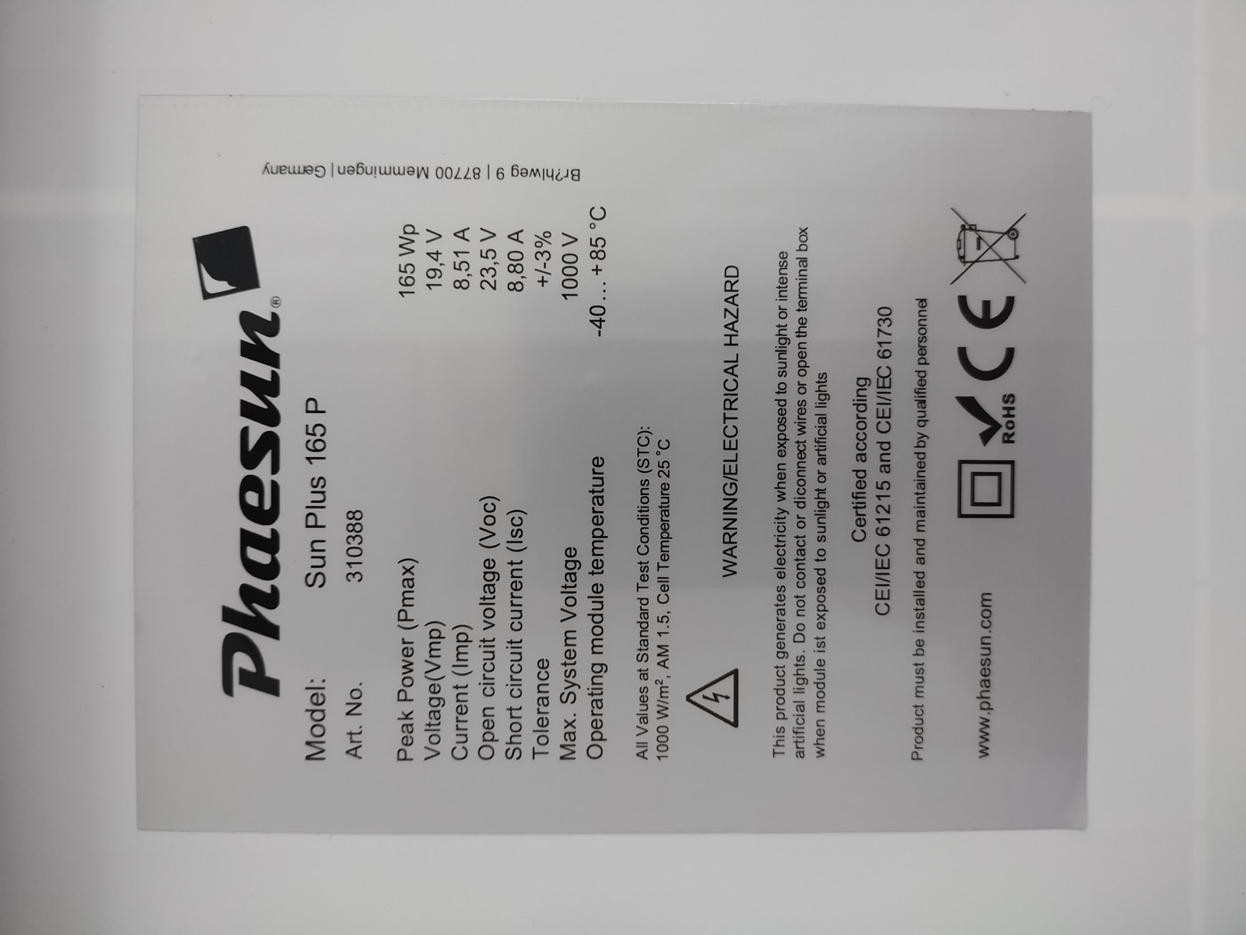 Close-up of a solar panel's rear specification and certification label listing power rating, voltage, and safety compliance marks