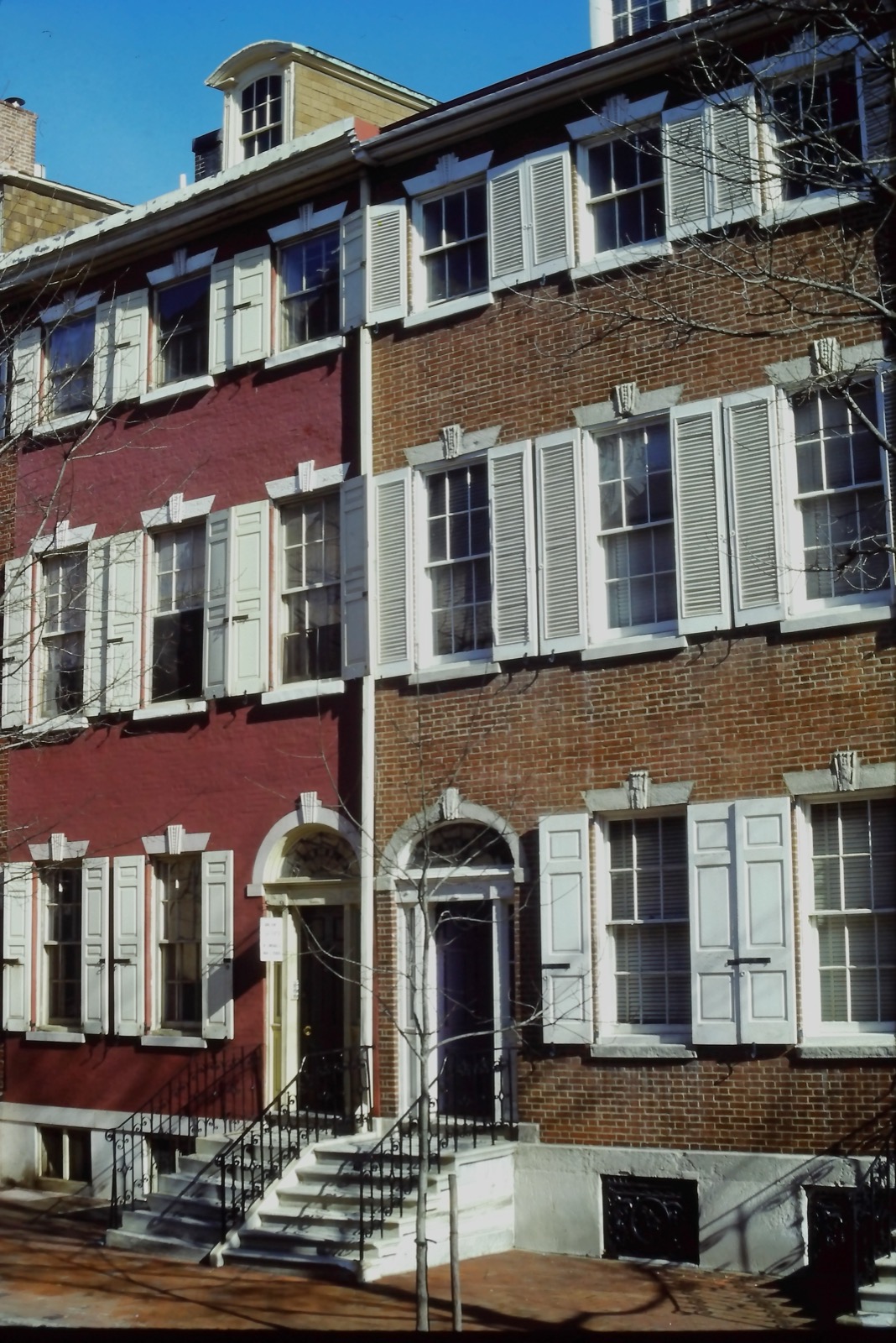 Federal-style brick rowhouses with white shutters in the Society Hill neighborhood of Philadelphia
