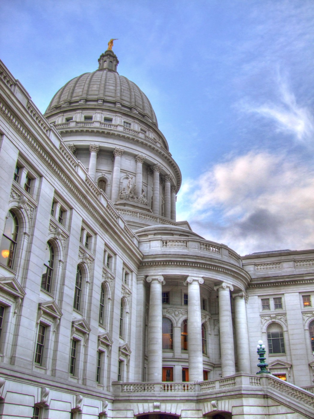 Exterior daytime view of the Wisconsin State Capitol building, home to a state legislature that funds and administers solar rebate programs
